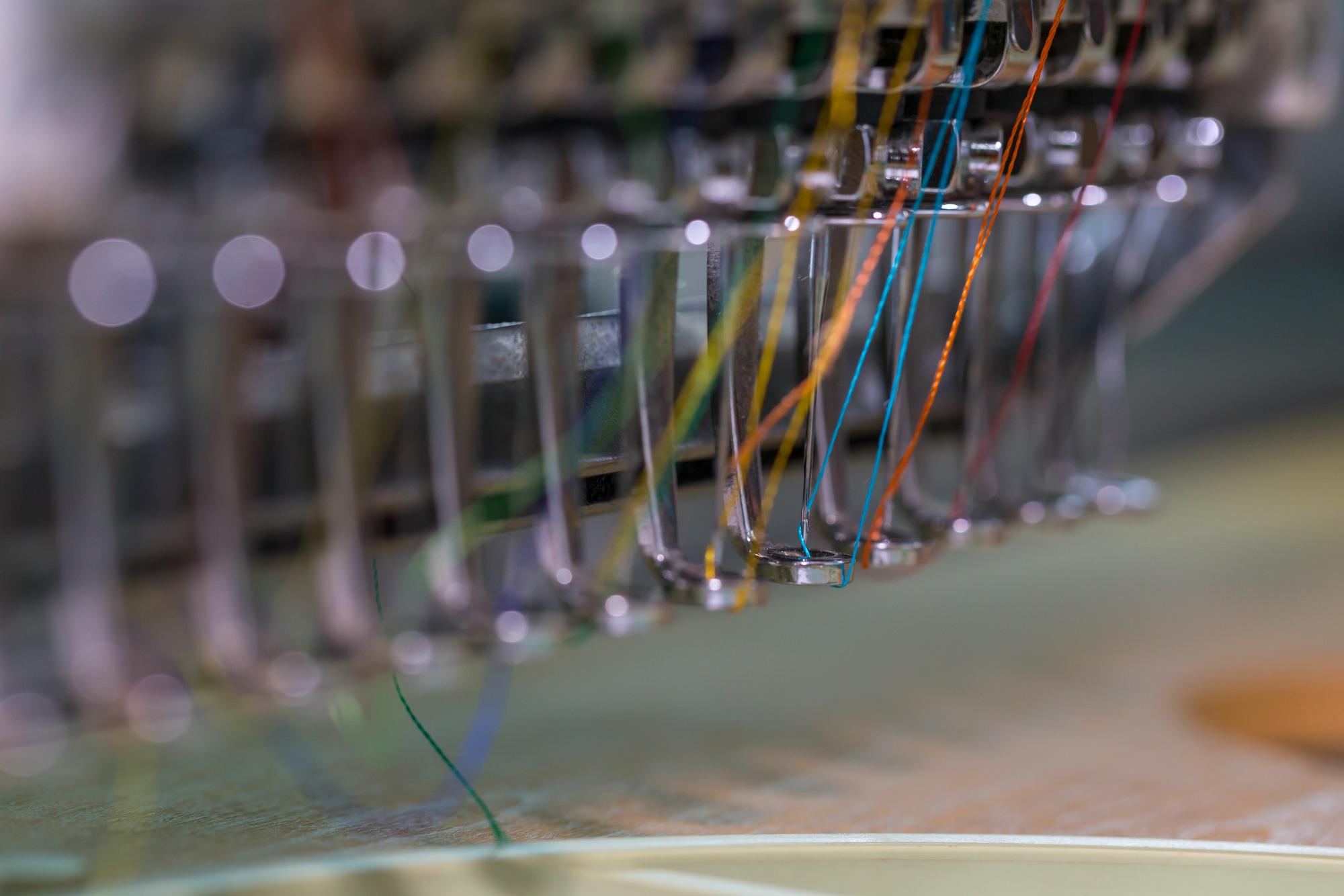 Studio with futuristic embroidery machine and threads